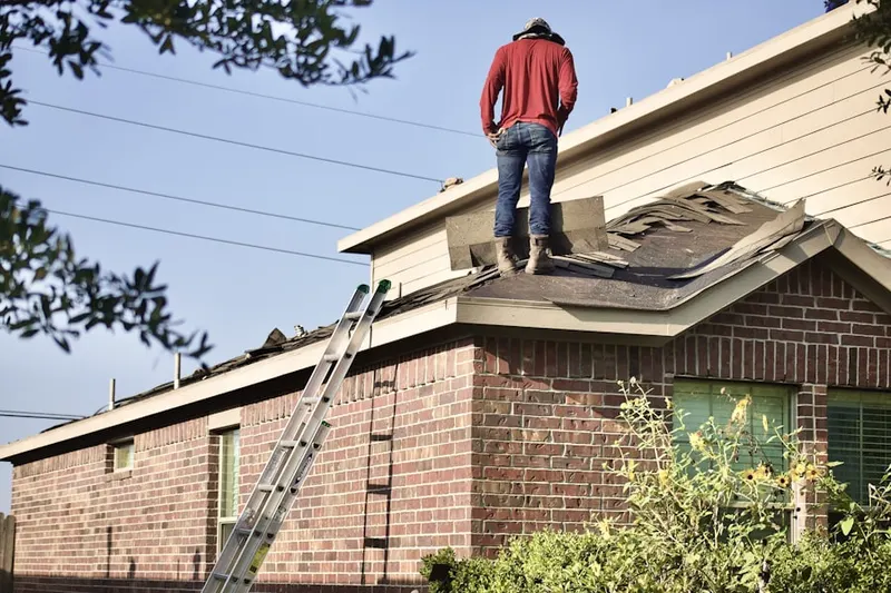 Professional roofer working on a residential roof in Cathedral City